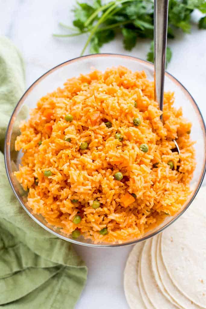 Mexican rice with peas and carrots served in a bowl