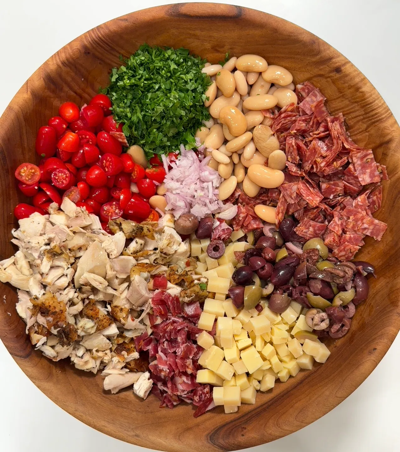 Charcuterie rotisserie chicken dense bean salad in a serving bowl