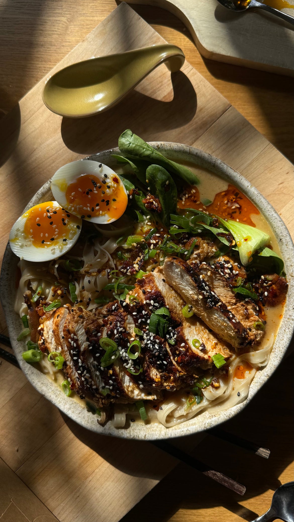 Creamy truffle miso ramen with chicken, jammy egg, mushrooms, and greens