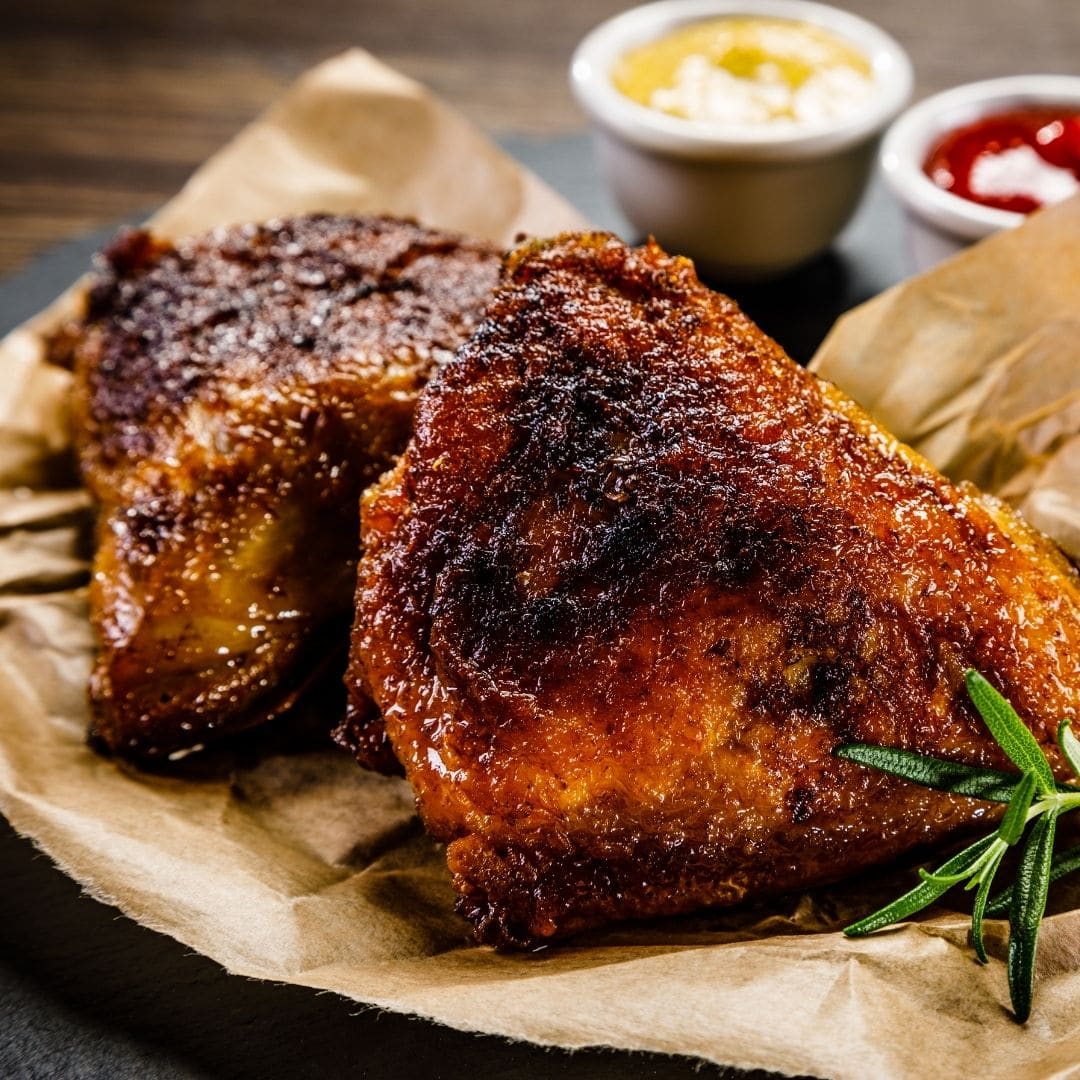 Grilled citrus-marinated chicken with charred edges on a platter