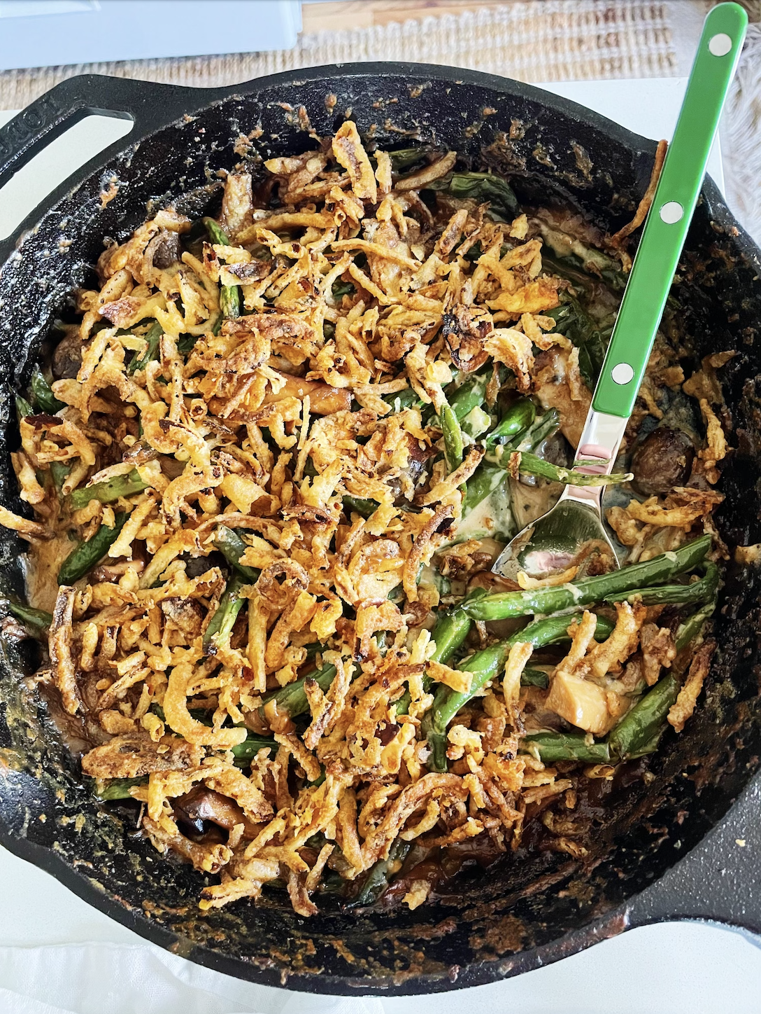Green bean casserole baked with crispy onions on top