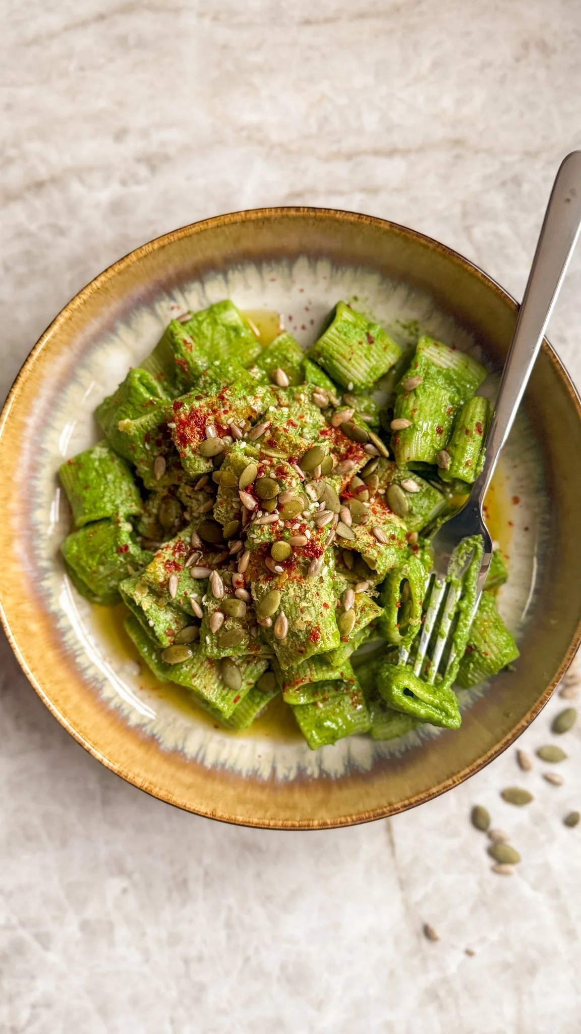 Green goddess rigatoni topped with mixed seeds