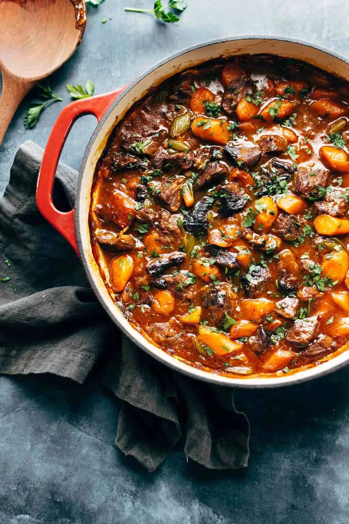 Rich beef stew with carrots and celery in a Dutch oven