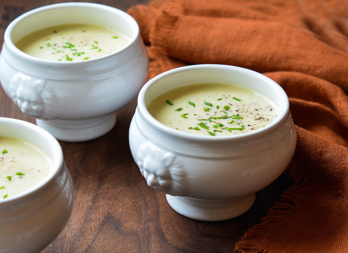 Creamy potato leek soup in a bowl with chives on top