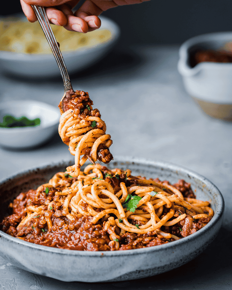 Red lentil bolognese twirled into pasta