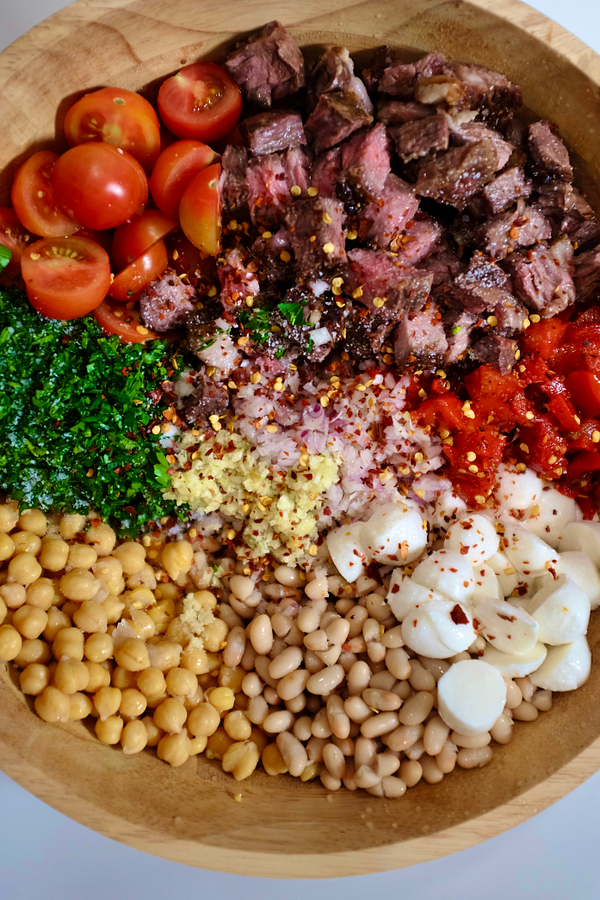 Steak chimichurri dense bean salad in a bowl
