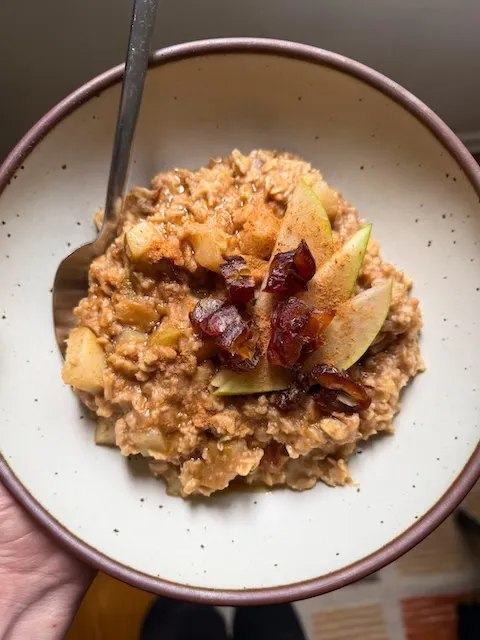Sticky toffee and spiced pear oatmeal in a bowl