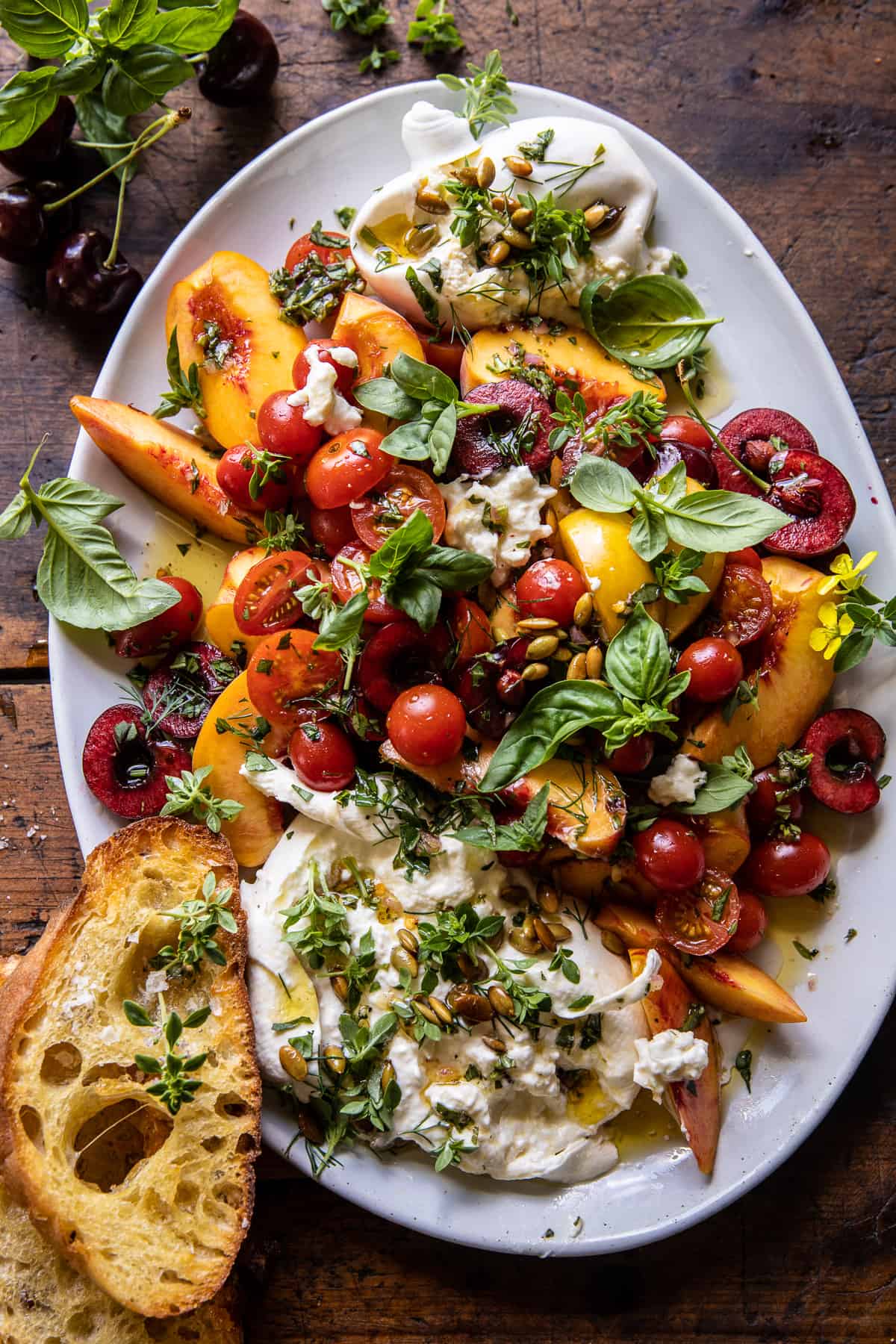 Tomato, peach, and burrata salad on a serving platter