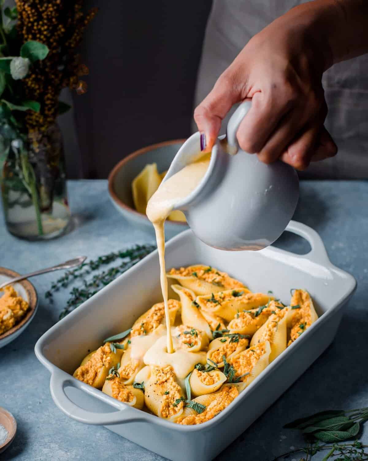 Vegan pumpkin ricotta stuffed shells baked with sauce
